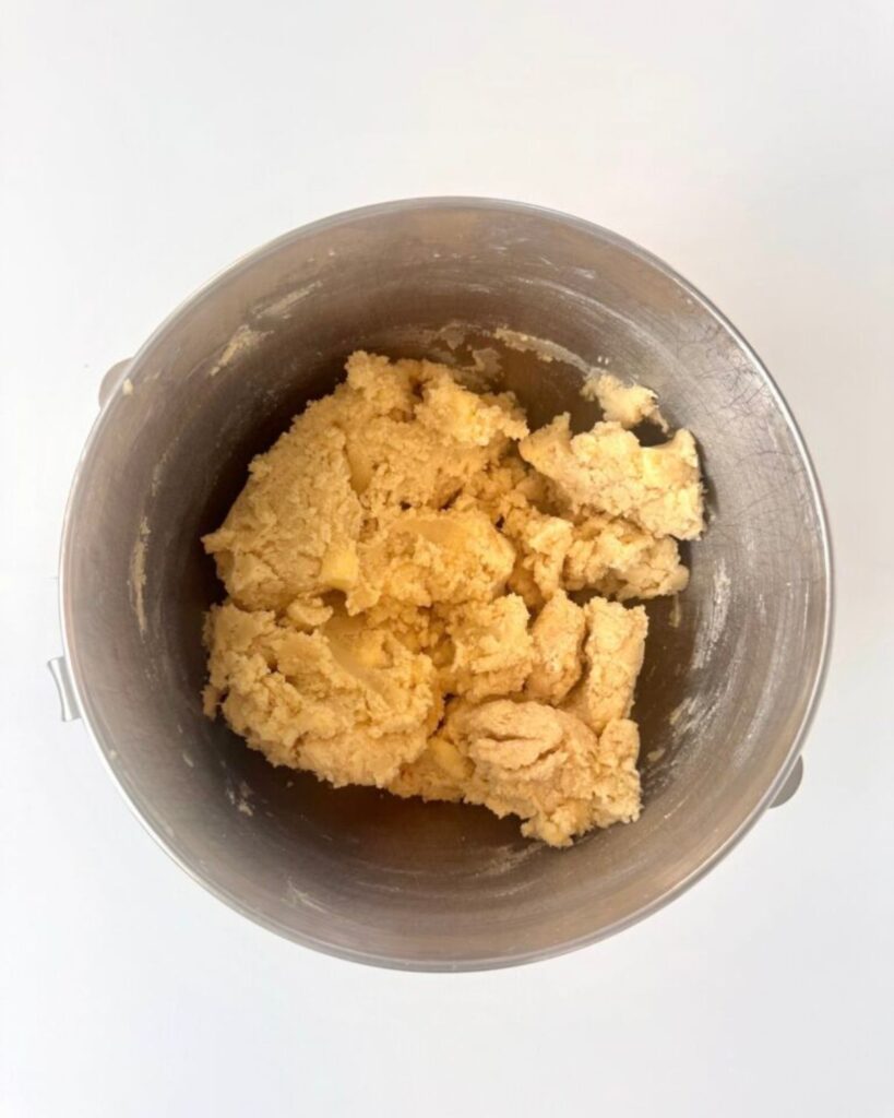 Finished almond shortbread cookie dough in a mixing bowl after the butter and flour are added.