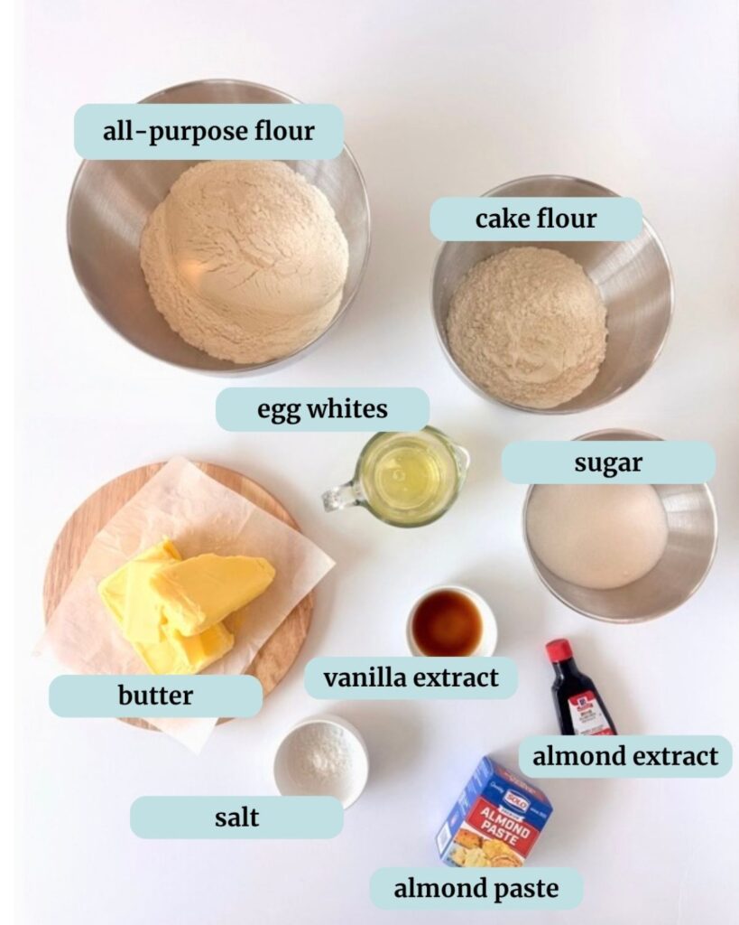 Labeled ingredients for almond shortbread cookies: all-purpose flour, cake flour, egg whites, sugar, butter, salt, vanilla extract, almond extract, and almond paste.